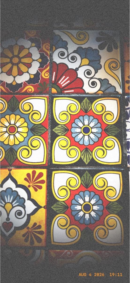 Painted ceramic tiles in red, yellow and blue on a wall in Brooklyn